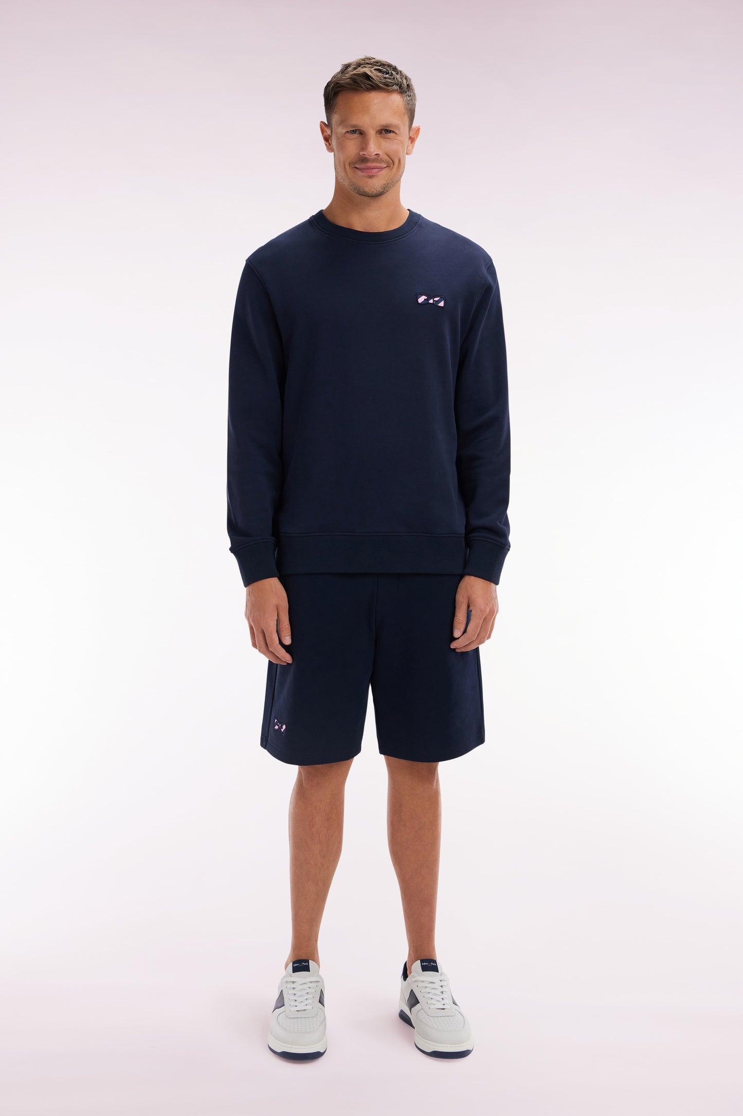Relaxed-fit navy cotton fleece shorts with a striped bow tie embroidery