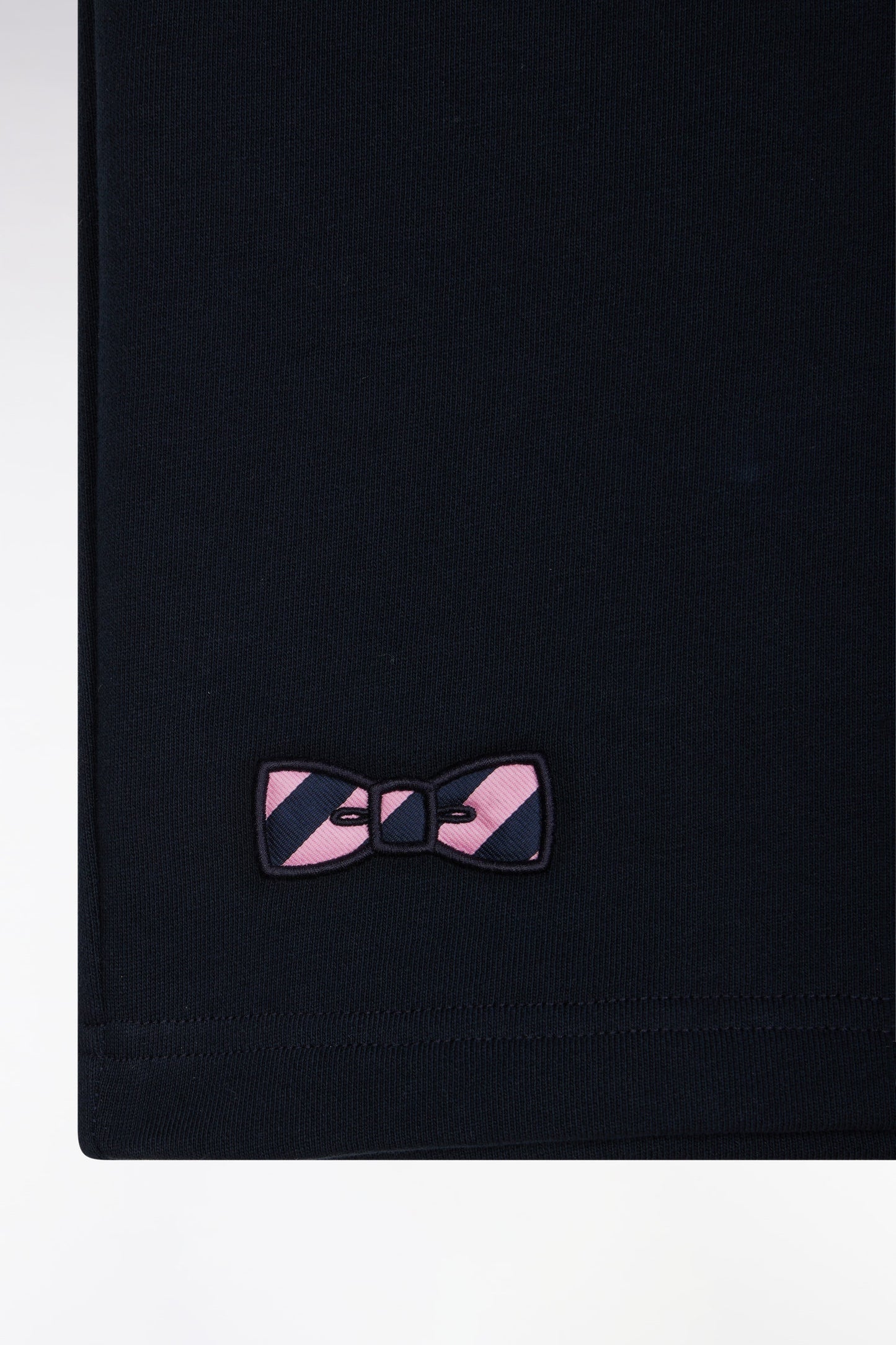 Relaxed-fit navy cotton fleece shorts with a striped bow tie embroidery