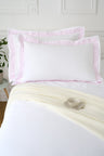 Set of rectangular pillowcases in white cotton with pink striped trim