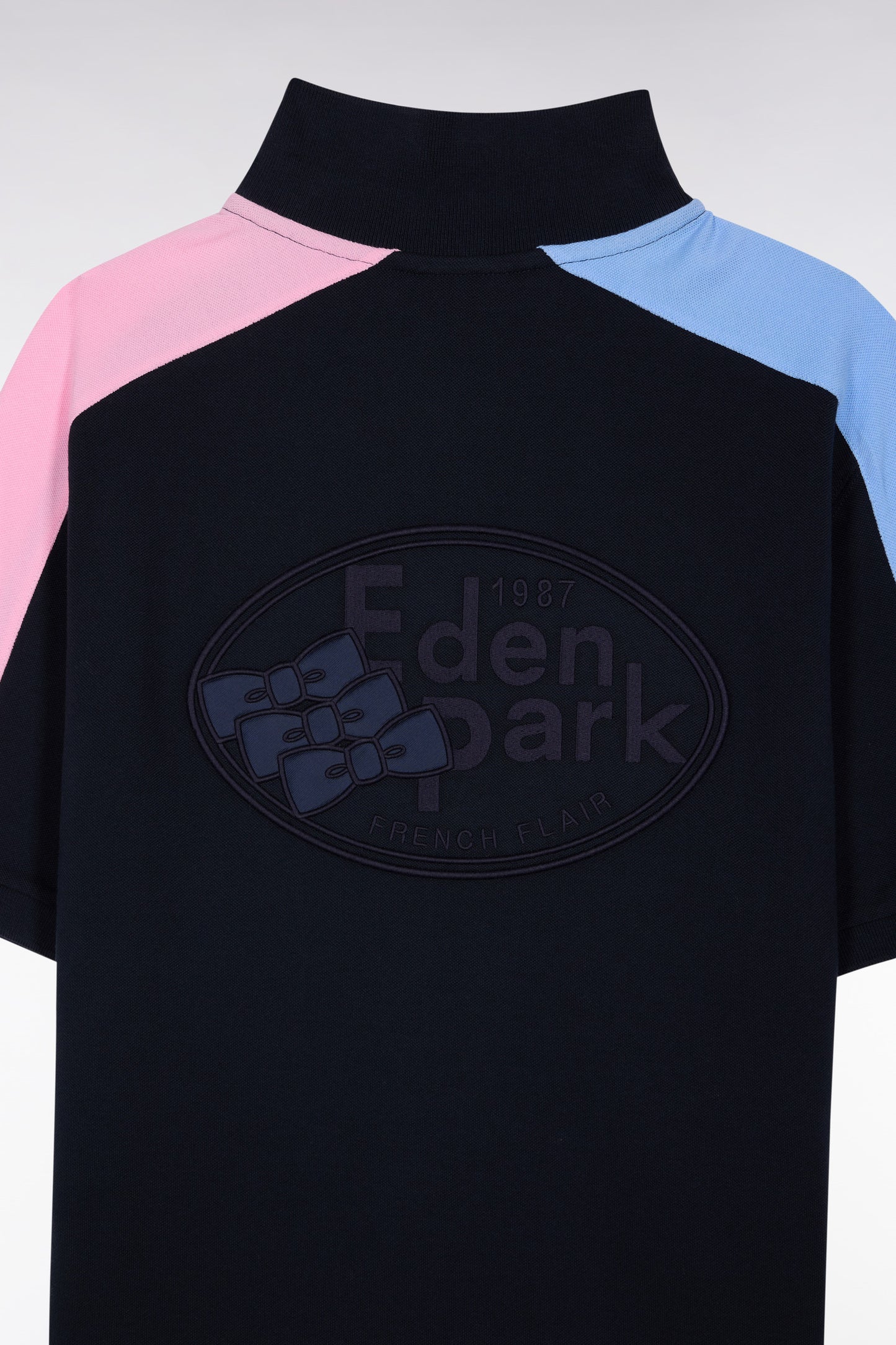 Short-sleeved polo shirt in navy cotton piqué with tricolored cut-outs