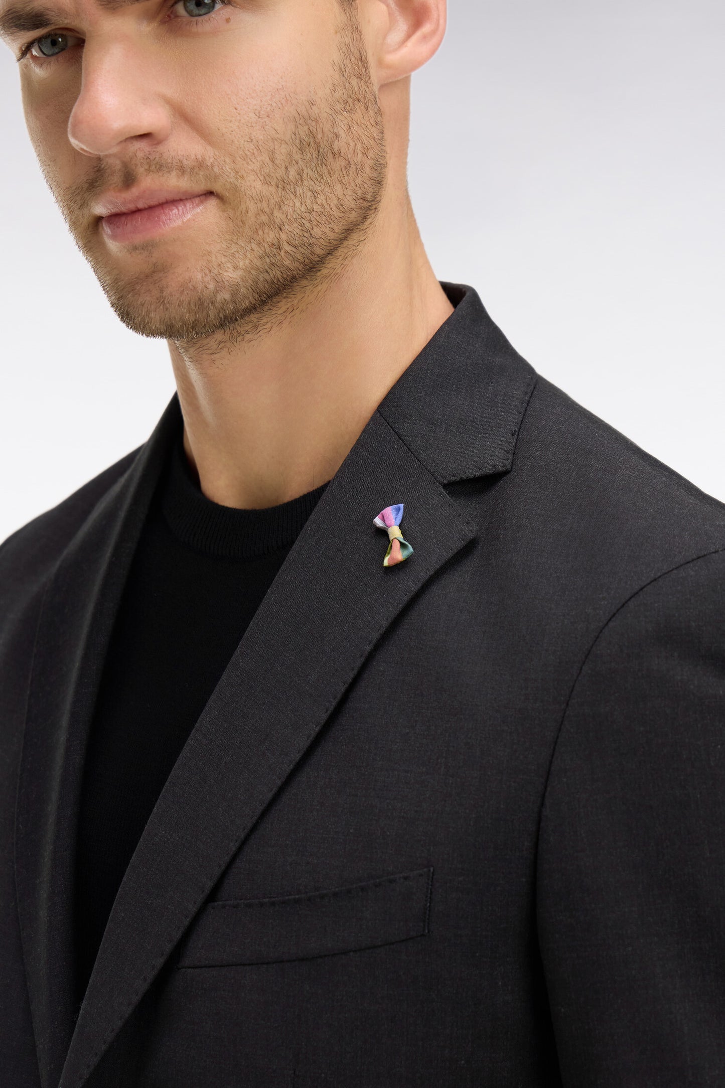 Dark grey blazer with embossed bow detail