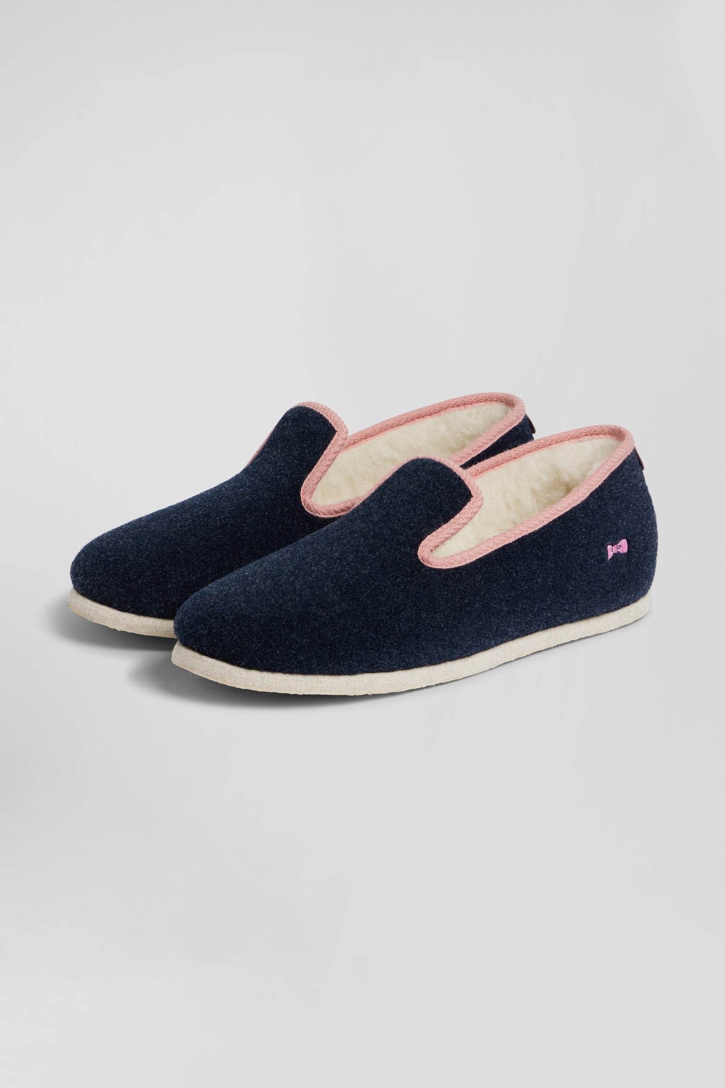 Navy blue shearling slippers with pink trim